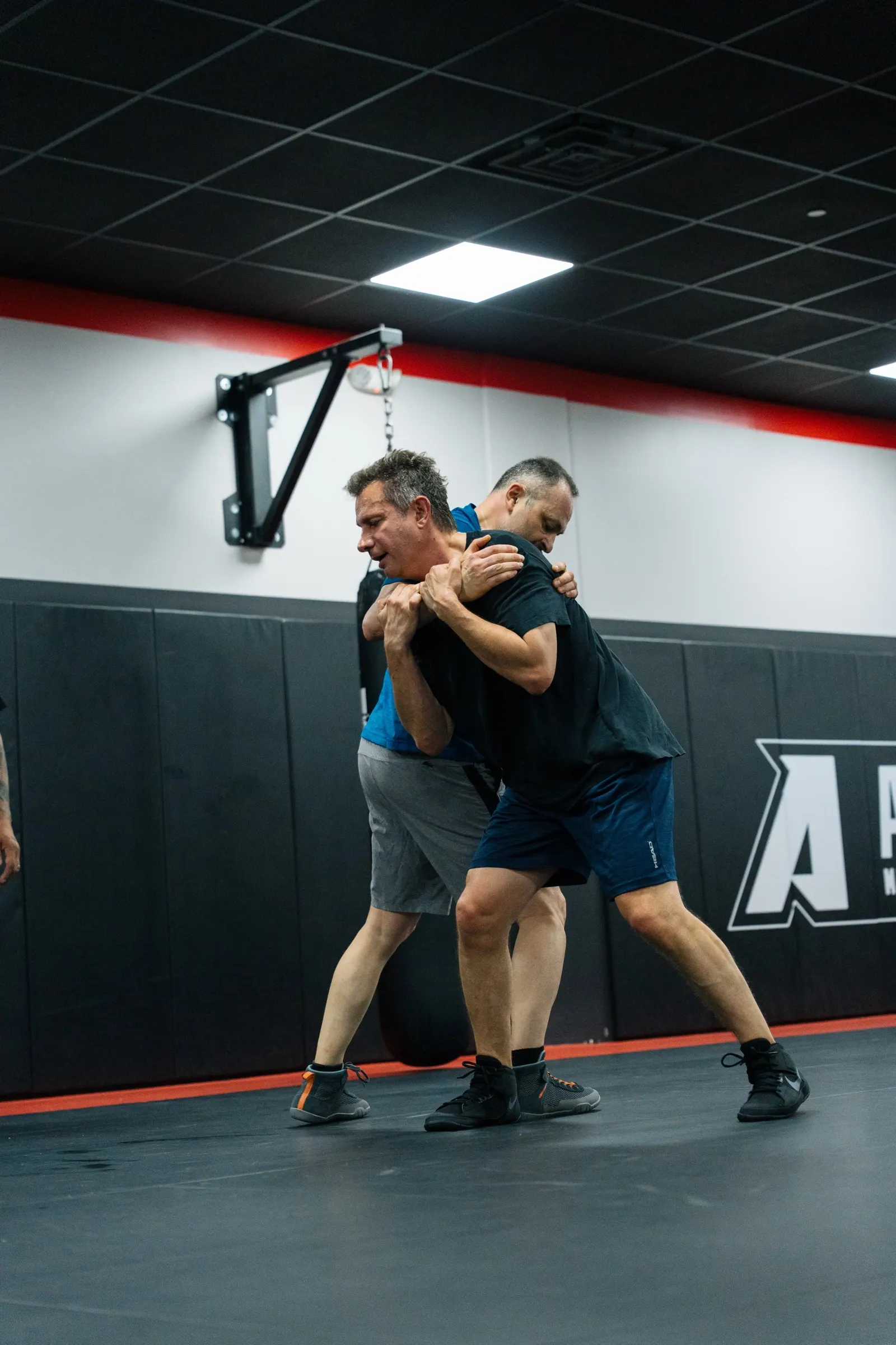 Instructor Dylan working a clinch sequence on the mat